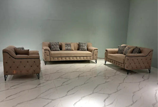 Brown sofa set with patterned cushions on a marble floor against a gray wall.