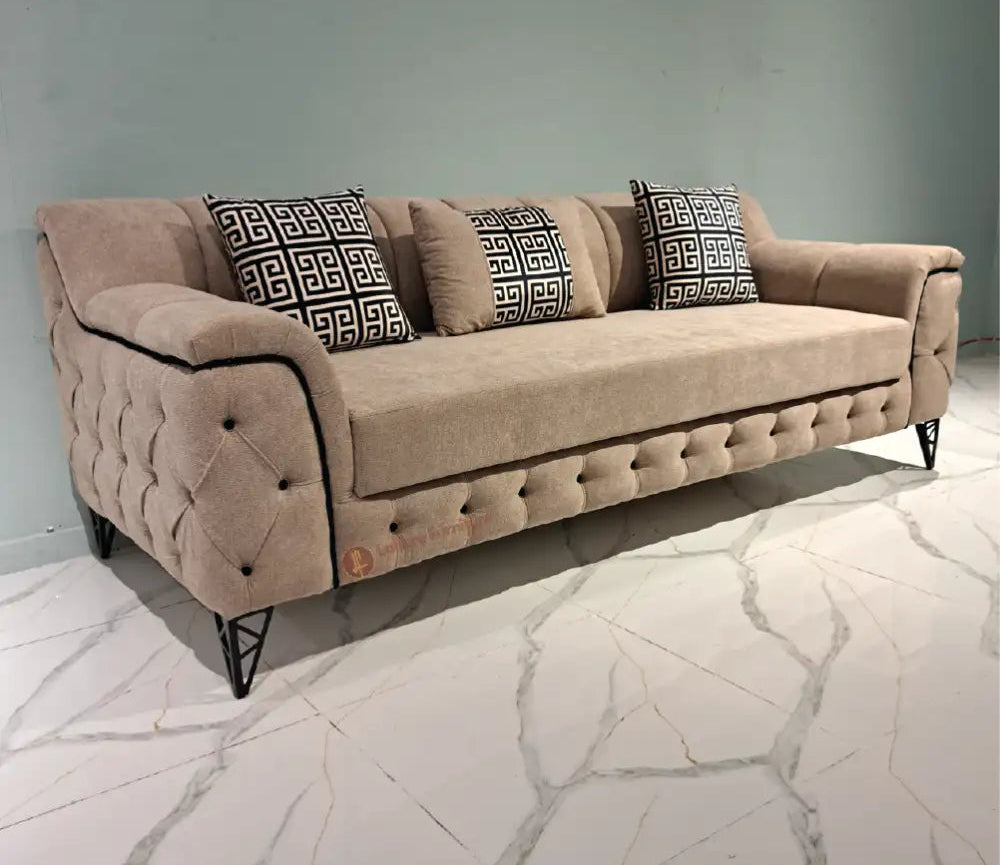 Beige sofa with decorative pillows on a marble floor, featuring Lahore Furniture logo.