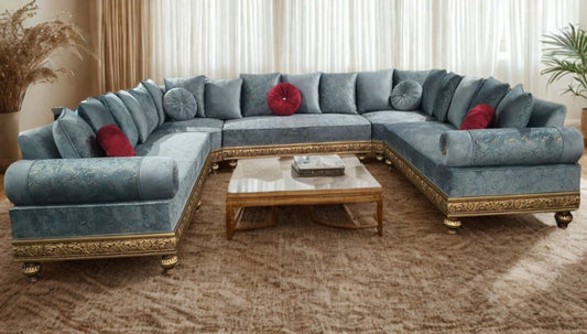 Blue sectional sofa with gold accents in a living room setting